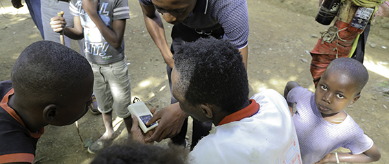 An outreach team member speaking with a family in Bas-Limbe, Haiti.